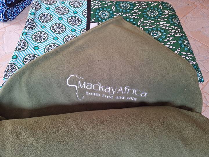 A logo embroidered in white on olive-green fleece