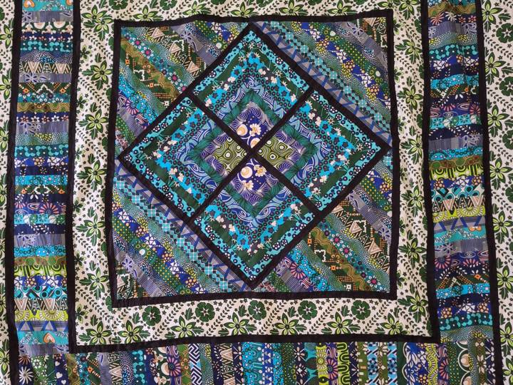 Close-up of a kanga patchwork quilt's medallion centre and borders