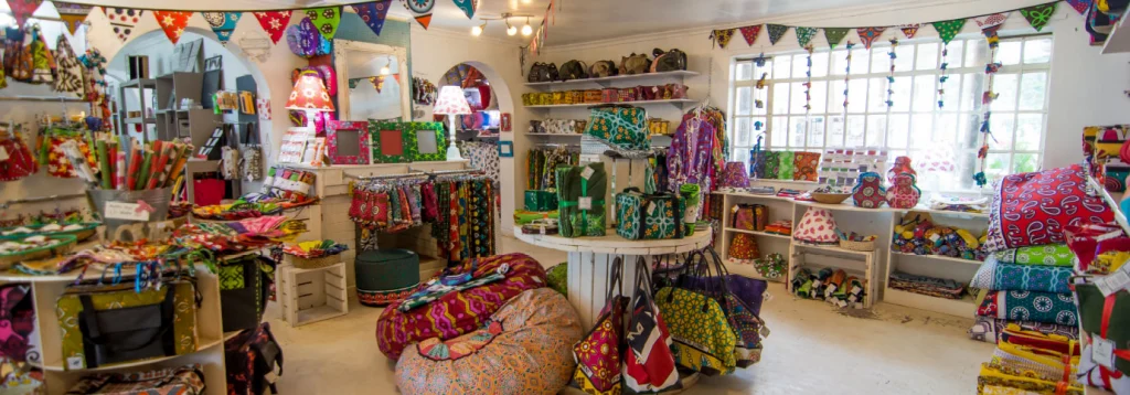 A shop hung with bunting and stocked with kanga bags, bean bags, cushions and lamps